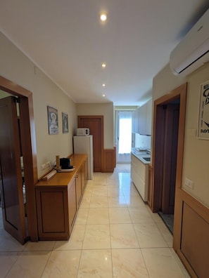 Eine Hotelküche mit einer Holzausstattung, einer Mikrowelle und einem Kühlschrank.