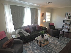 A living room with a sofa, armchair, coffee table, and a small side table. - Hero's Hideaway, North Jackson, Sleeps 8 (Jackson)