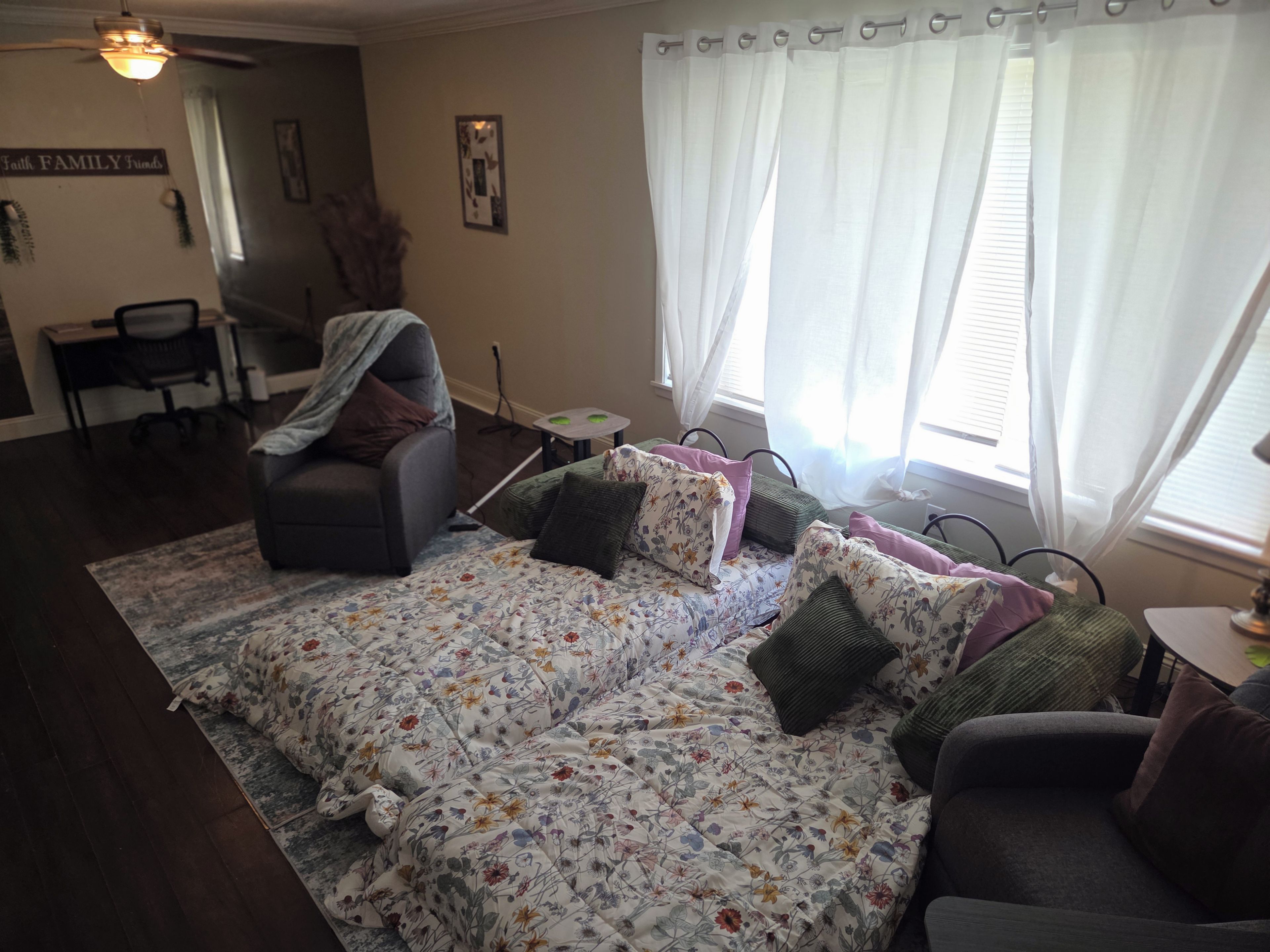 A living room with a sofa set, a dining table, and a chair.