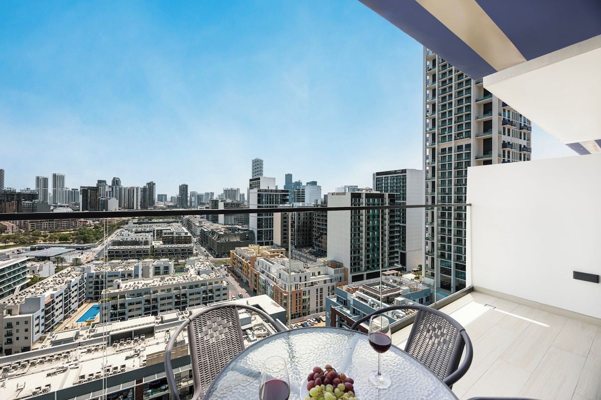 A high-rise building with a glass balcony overlooking a cityscape.