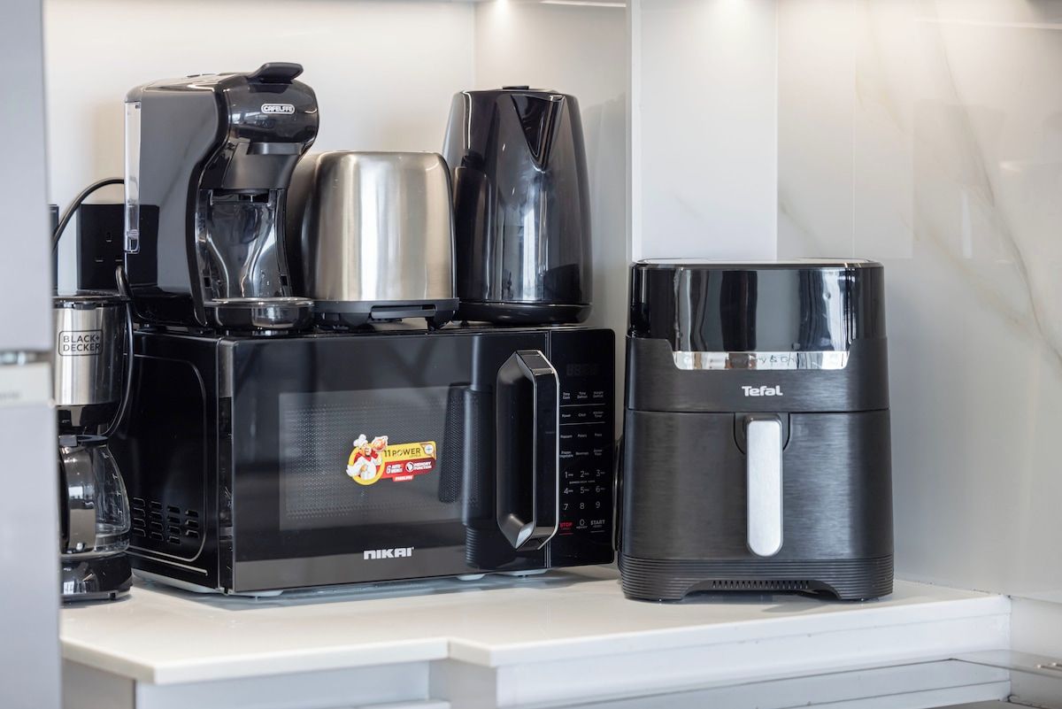 A coffee maker and a Teafal coffee pot on a countertop.