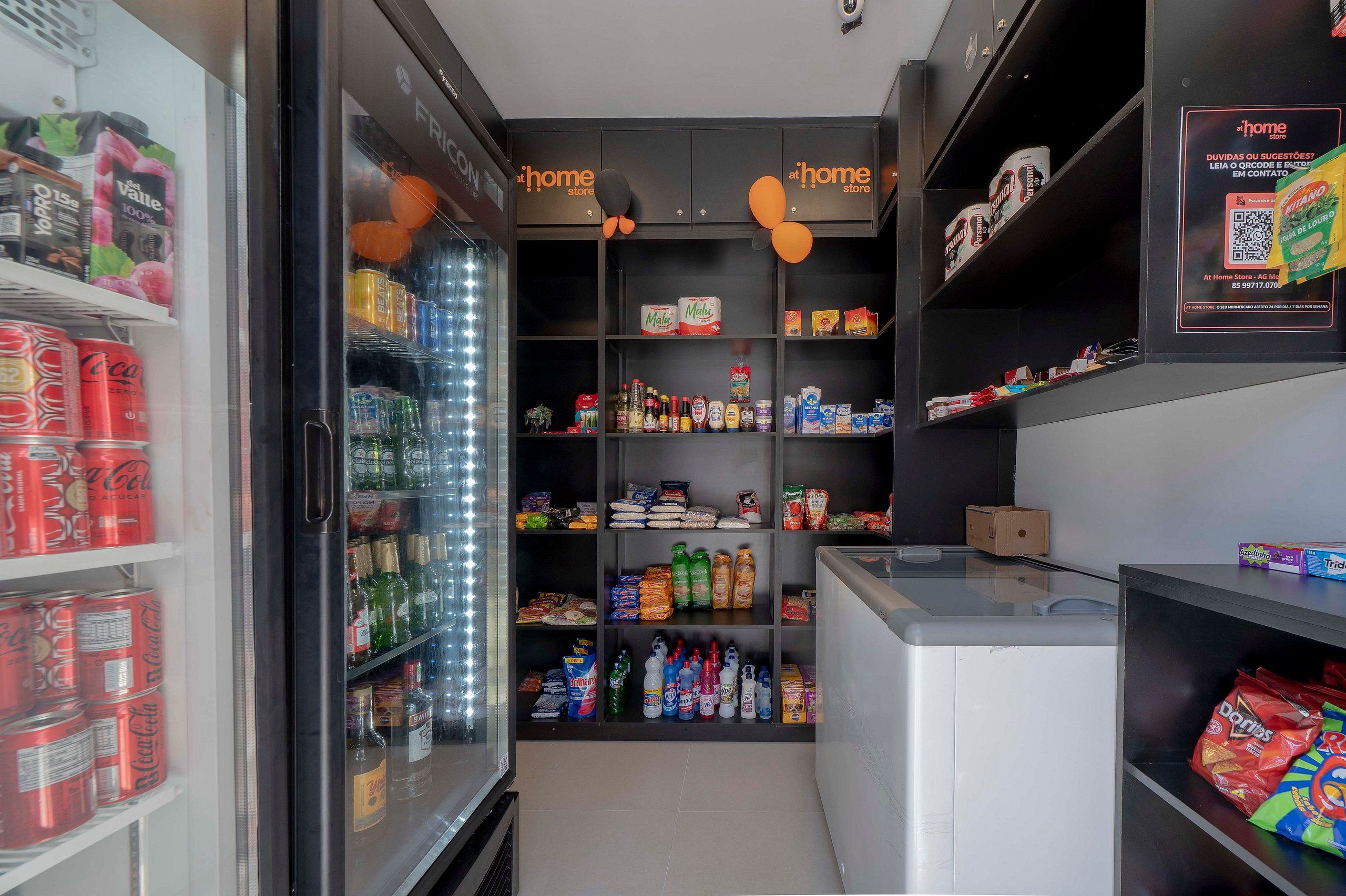 A small, well-organized pantry with shelves stocked with various food items, including canned goods, bottles, and snacks.