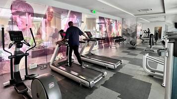 A gym with treadmills, stationary bikes, and weight machines.