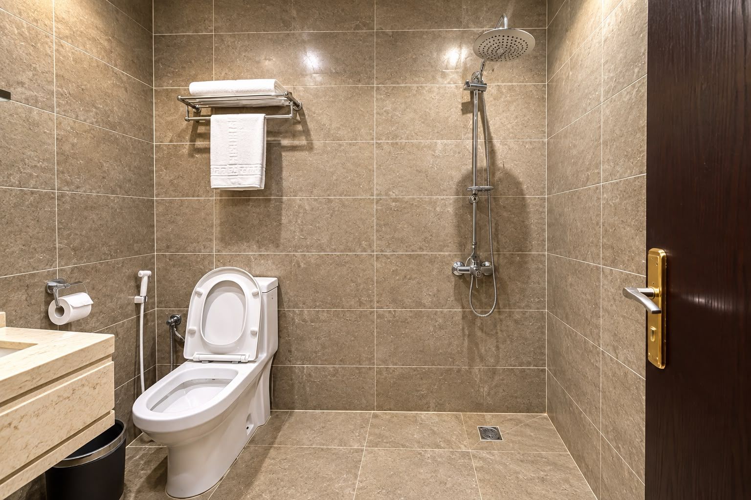 A bathroom with a toilet, sink, and shower.