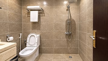 A bathroom with a toilet, sink, and shower.
