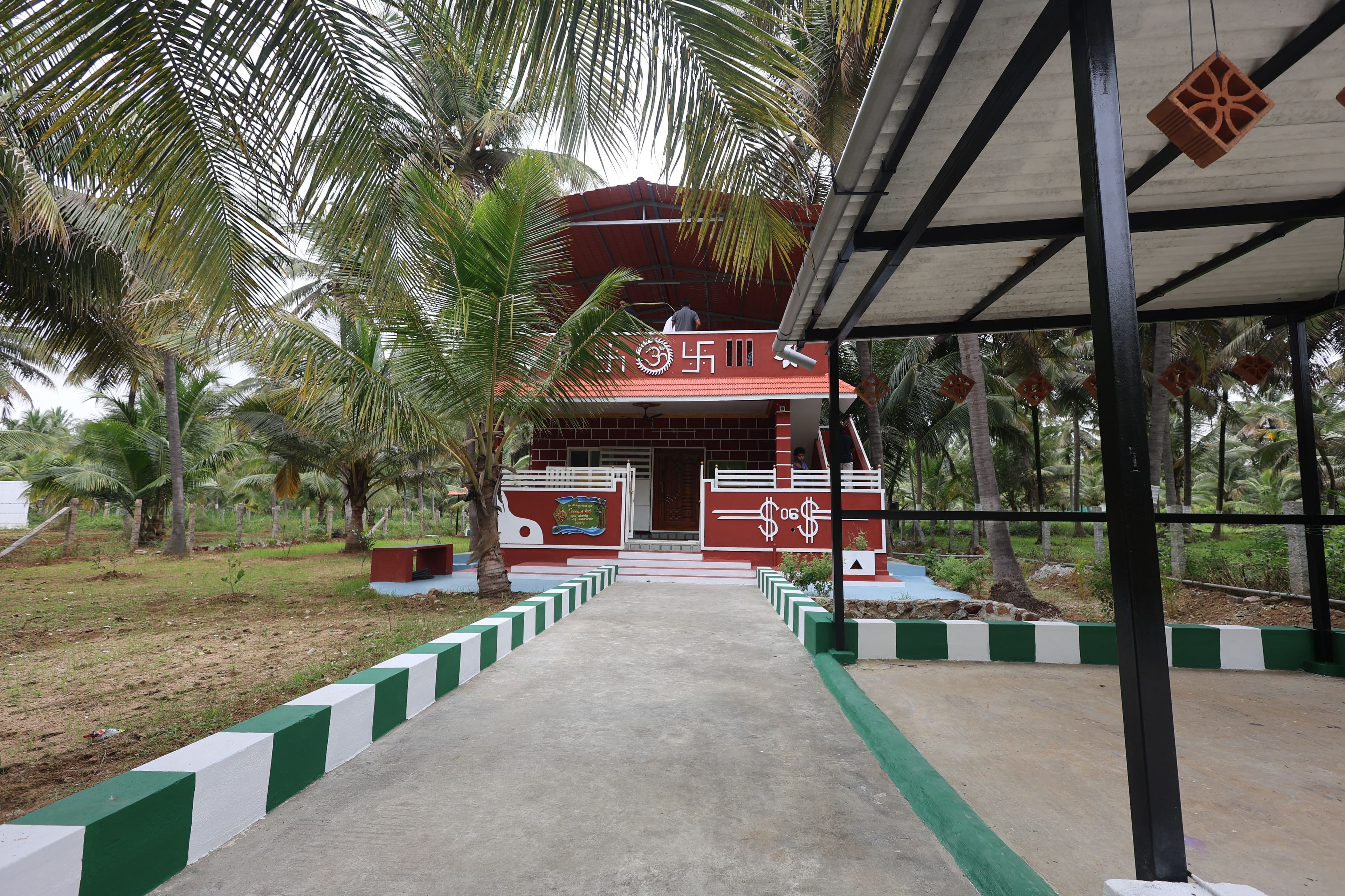 A building with a red roof and a sign with a symbol and text.