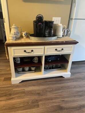 A kitchen counter with a coffee maker, a kettle, and a teapot. - “The Nautical Nest” less than 1 mile to KY lake with boat parking on premises. (Dover)