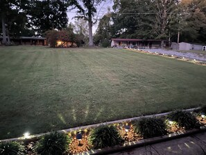 A well-maintained lawn with a pathway leading to a building. - “The Nautical Nest” less than 1 mile to KY lake with boat parking on premises. (Dover)