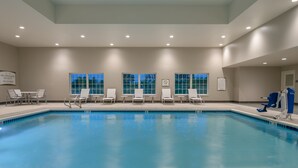 A swimming pool with white lounge chairs and a no diving sign on the wall. - 1 Bedroom King Suite w/ Full Kitchen + Breakfast (Hillsboro)