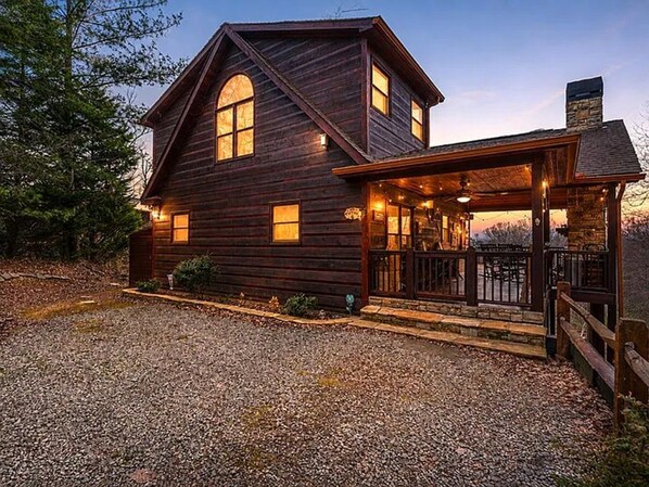 A two-story wooden cabin with a porch and a stone chimney. - Work Hard Play Hard- View-Gameroom (Blue Ridge)