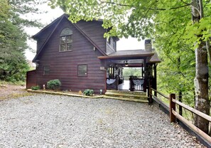 A rustic wooden house with a porch and a gravel driveway. - Work Hard Play Hard- View-Gameroom (Blue Ridge)