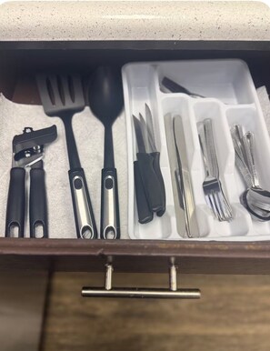 A drawer with compartments containing various kitchen utensils. - Spacious 1bdr Townhome Minutes from ATT Stadium (Arlington)
