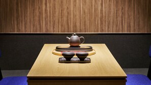 A wooden table with a teapot and two cups on a tray. - Mitasuya Ryokan Hotel by Anook Daejeon Yongmun (Daejeon)