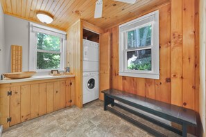 A compact kitchen with wooden cabinets, a washing machine, and a bench. - The Overlook, Lake Wallenpaupack, Boat Slip+Kayak, Private Dock (Greentown)