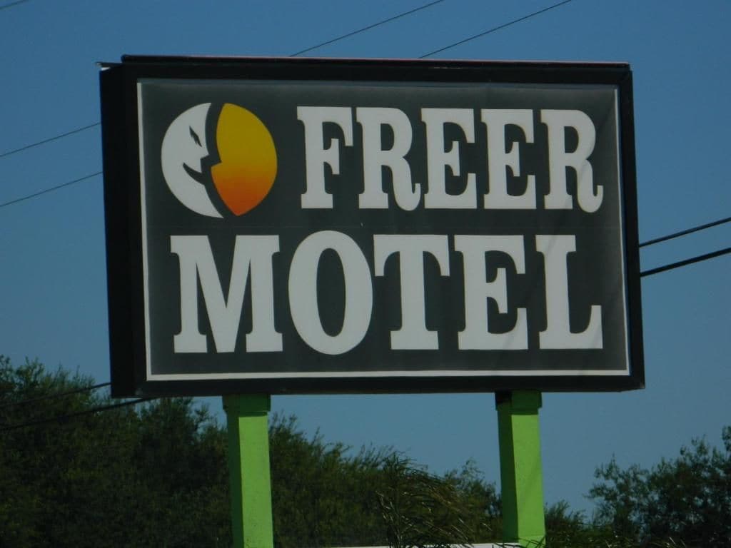 A sign for a motel with a partial moon and sun graphic.