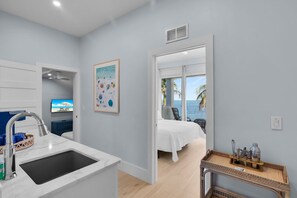A modern bathroom with a marble sink, a shower area, and a view of the ocean through an open door. - Gulfstream Paradise Open Water on the Gulf  6 bed 4 bath with pool, 4 kayaks, and dockage (Marathon)