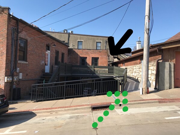 A street view with a brick building, a metal fence, and a utility pole. - Walk to everything! This apartment puts you in the heart of historic Galena! (Galena)