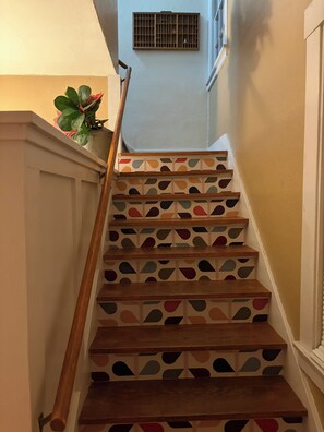 A staircase with wooden steps and a geometric pattern on the risers.