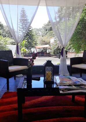 An outdoor seating area with two chairs, a table, and a lantern.