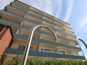 A multi-story building with balconies and a metal structure in the foreground. - Holiday Apartment in Fohr With 1 Bedroom (Wyk auf Foehr)