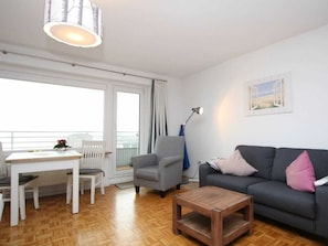A living room with a sofa, a coffee table, a chair, a desk, and a lamp. - Holiday Apartment in Fohr With 1 Bedroom (Wyk auf Foehr)