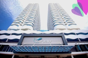 A hotel with a wave-themed facade and a prominent logo. - The Wave Residence (Malacca)