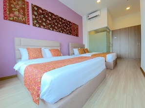 A hotel room with two beds, a large mirror, and a wardrobe. - The Wave Residence (Malacca)