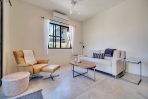 A modern living room with a sofa, armchair, ottoman, and coffee table. - Baja Sage (El Pescadero)