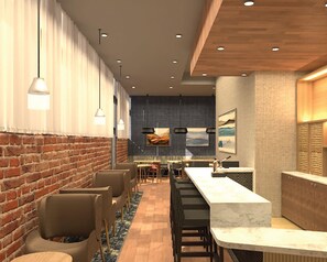 A modern interior with a brick wall, wooden ceiling, and a long counter with seating.