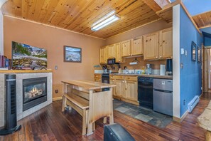 A modern kitchen with wooden cabinets, a built-in microwave, and a dishwasher. - Spacious 2-bedroom loft condo in downtown Estes Park - walk to restaurants/shops (Estes Park)