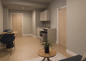 A compact living space with a dining area, kitchenette, and a small seating area with a plant. - Student Only Glasgow Citi View (Glasgow)