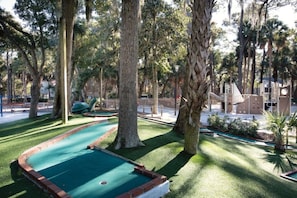 A pool table in a shaded area surrounded by trees. - BLOCK Blue Ridge Village 1br (Banner Elk)