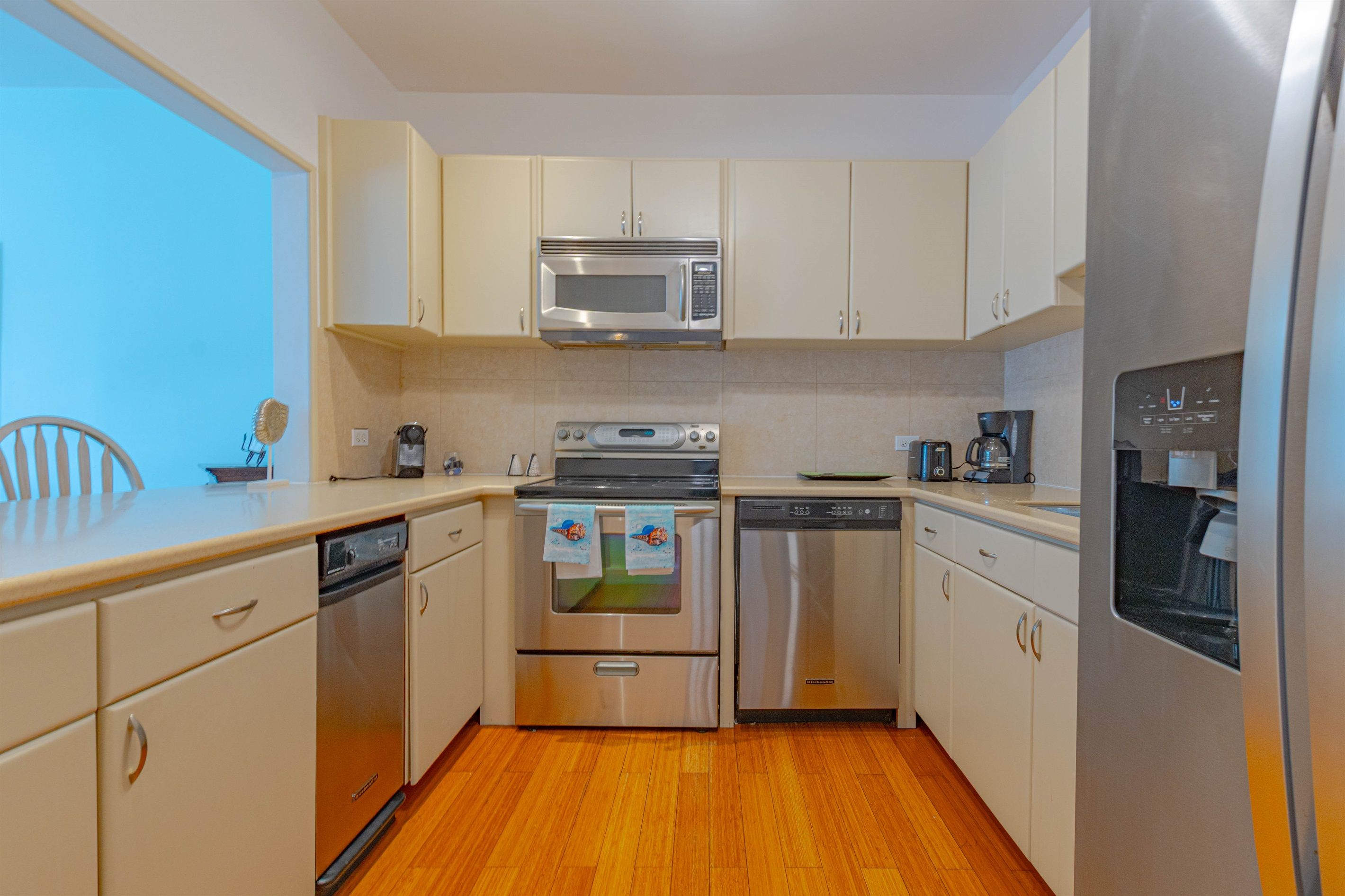 A compact kitchen with a microwave, oven, and dishwasher.