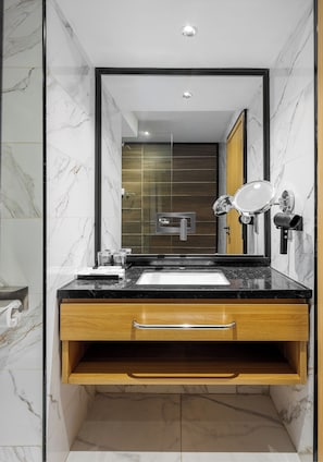 A modern bathroom with a marble vanity, a sink, a mirror, and a towel rack. - Best Western Plus Ambience Hotel Ikeja (Lagos)