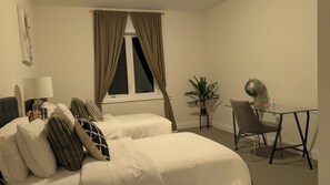 A hotel room with two beds, a desk, a chair, a globe, and a potted plant. - Minutes to Ski ,Golf & Spa | Private Retreat (Oro-Medonte)