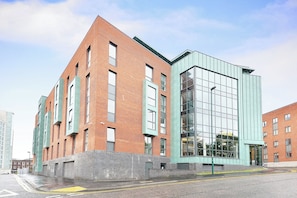 A modern building with a brick facade and large windows. - Student Only Miura (Nottingham)