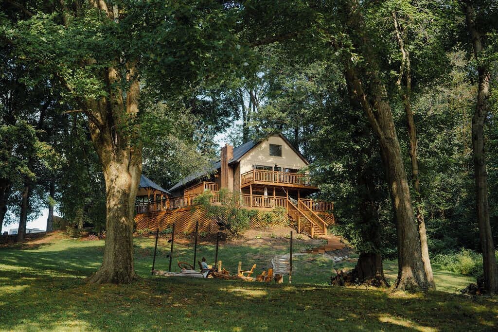 A large wooden house surrounded by trees.