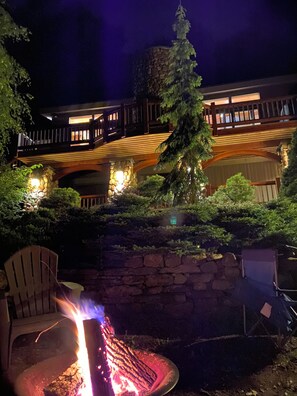 A stone wall, a wooden deck, and a fire pit area. - Luxury Windham Escape w/ Hot Tub, Views & Walk to Mountain (Windham)