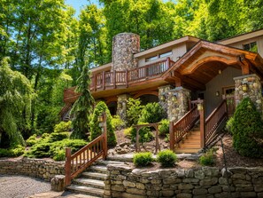 A two-story house with a stone chimney, wooden deck, and a stone staircase leading to the entrance. - Luxury Windham Escape w/ Hot Tub, Views & Walk to Mountain (Windham)