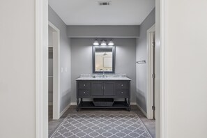 A bathroom with a vanity, mirror, and lighting. - Spacious 5BR Home with Private Pool & 11-Mile Lagoon Views (Hilton Head Island)