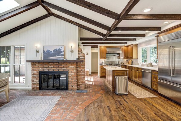 A spacious kitchen with a large island, a built-in oven, and a stainless steel refrigerator. - Pinecrest Peak! Hot Tub & Sauna Near Broadmoor (Colorado Springs)