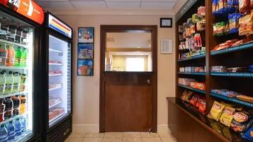 A vending area with snacks and a Coca-Cola refrigerator.