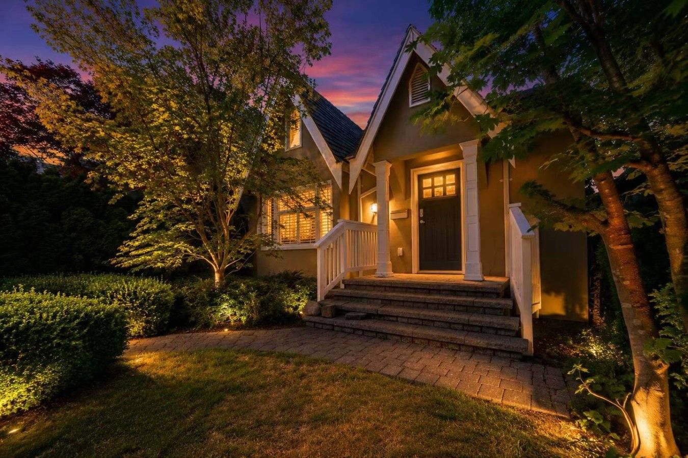 A house with a front porch, steps, and a door.