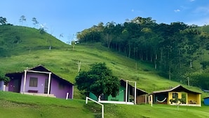 A hillside with several small, colorful cabins.