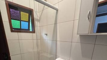 A bathroom with a toilet, bidet, and sink.