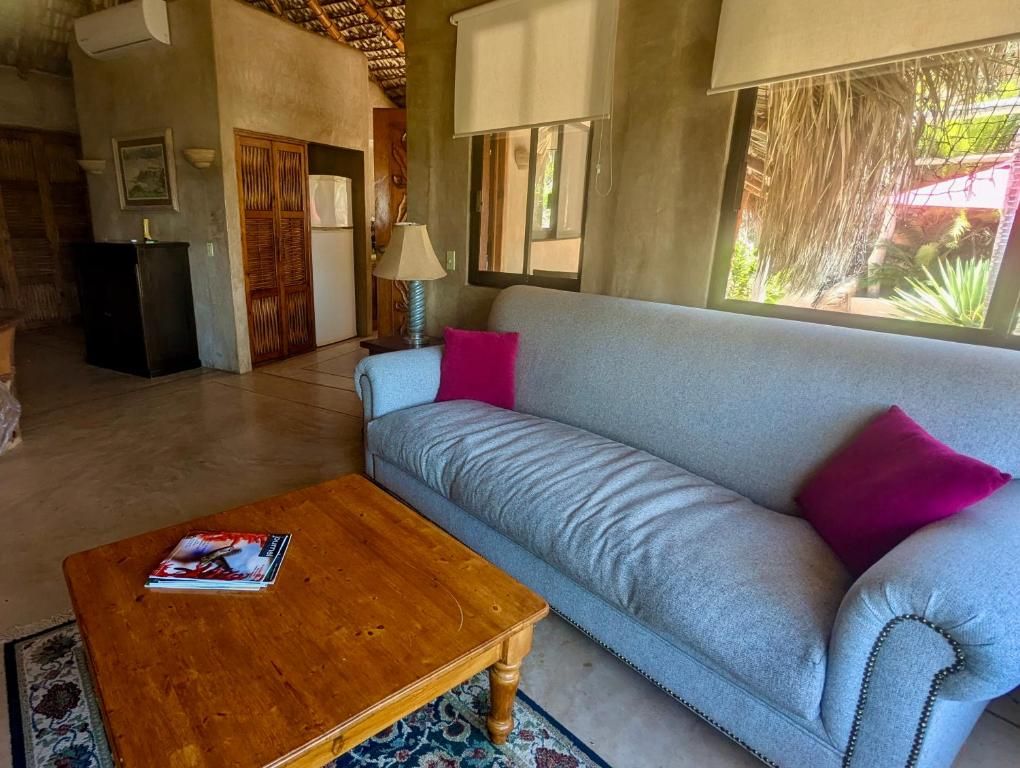 A living room with a sofa, a coffee table, and a lamp.