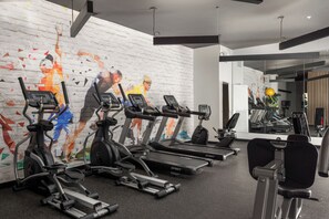 A gym with multiple treadmills, stationary bikes, and a mirrored wall. - Duck Island 1BR , Walk to Ohio City + Parking (Cleveland)