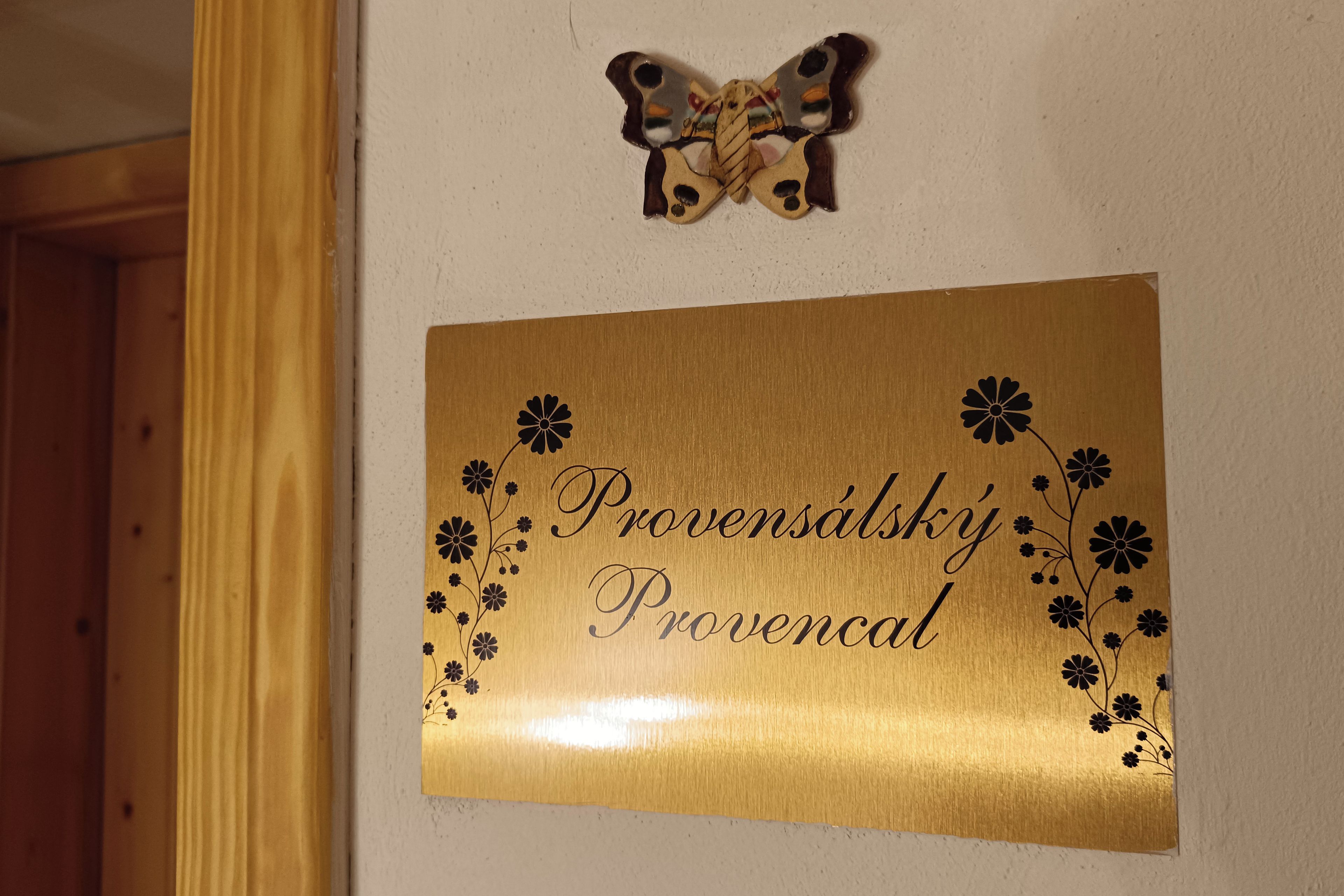A plaque with the text 'Provensalsky Provencal' and a decorative butterfly.