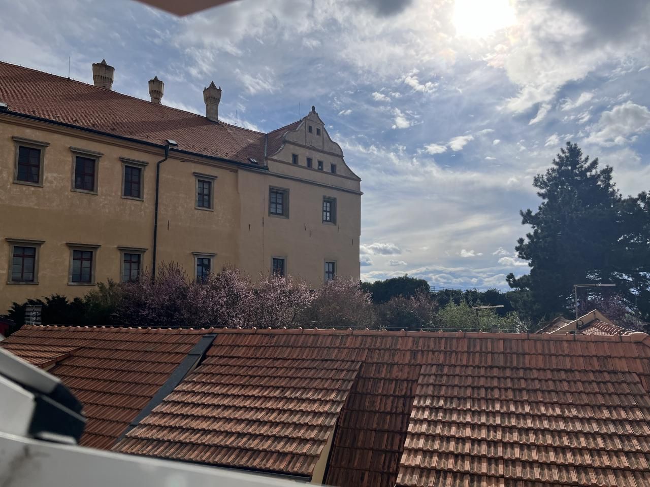 A building with a tiled roof and a large window.