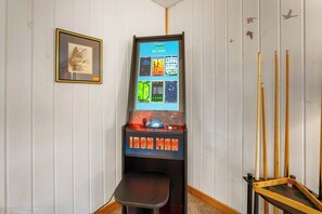 A room with a pool table, a framed picture on the wall, and a video game machine. - Gatlinburg Mountain Cabin Views Hot Tub Game Room Sleeps 9 (Gatlinburg)
